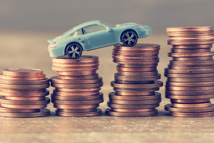 Car on coins representing a car retaining its value with the help of car services in Springfield, Illinois