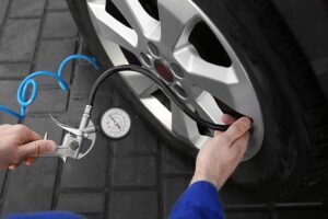 Tire pressure is being checked by a professional mechanic in Springfield, Illinois.
