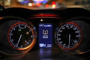 A tire pressure light on the dashboard of a modern vehicle in Springfield, IL, that requires tire repair and maintenance services.