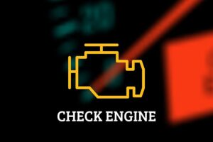 A close-up image of a check engine light on the dashboard of a vehicle that requires repair from a professional mechanic in Springfield, IL.