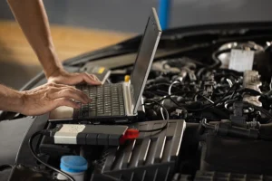 Mechanic in Springfield, IL performing an electrical system maintenance check through computer diagnostic services.