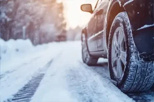 Jack Stoldt Auto Service Center - A car driving through the snow in Springfield, IL, after being winterized, so it's safe on the road.