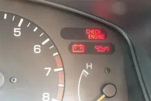 Jack Stoldt Auto Service Center – Check engine, battery, and oil warning lights illuminated on a car's dashboard in Springfield, IL.