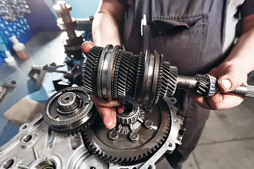 Jack Stoldt Auto Service Center—A professional mechanic works on the transmission of a vehicle in his Springfield, IL shop.