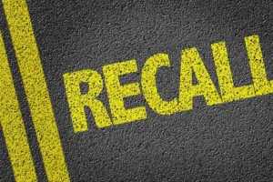 Jack Stoldt Auto Service Center—The word “recall” painted in yellow on an asphalt road in Springfield, IL.