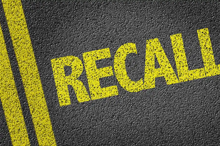 Jack Stoldt Auto Service Center—The word “recall” painted in yellow on an asphalt road in Springfield, IL.