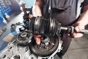 Jack Stoldt Auto Service Center—A professional mechanic works on the transmission of a vehicle in his Springfield, IL shop.
