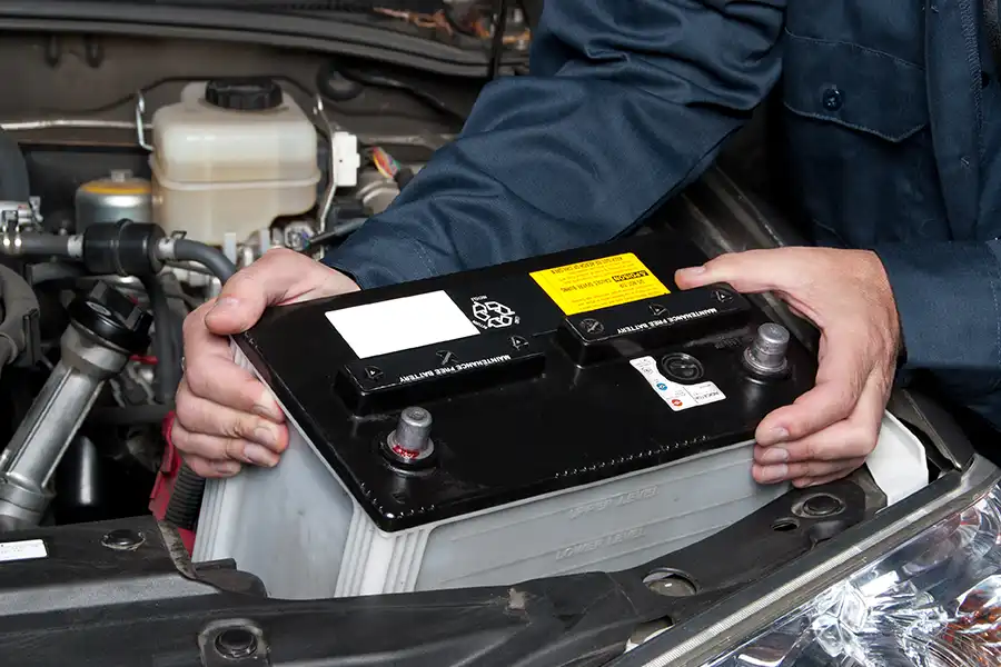 Jack Stoldt Auto Service—An auto mechanic replaces a car battery in Springfield, IL.